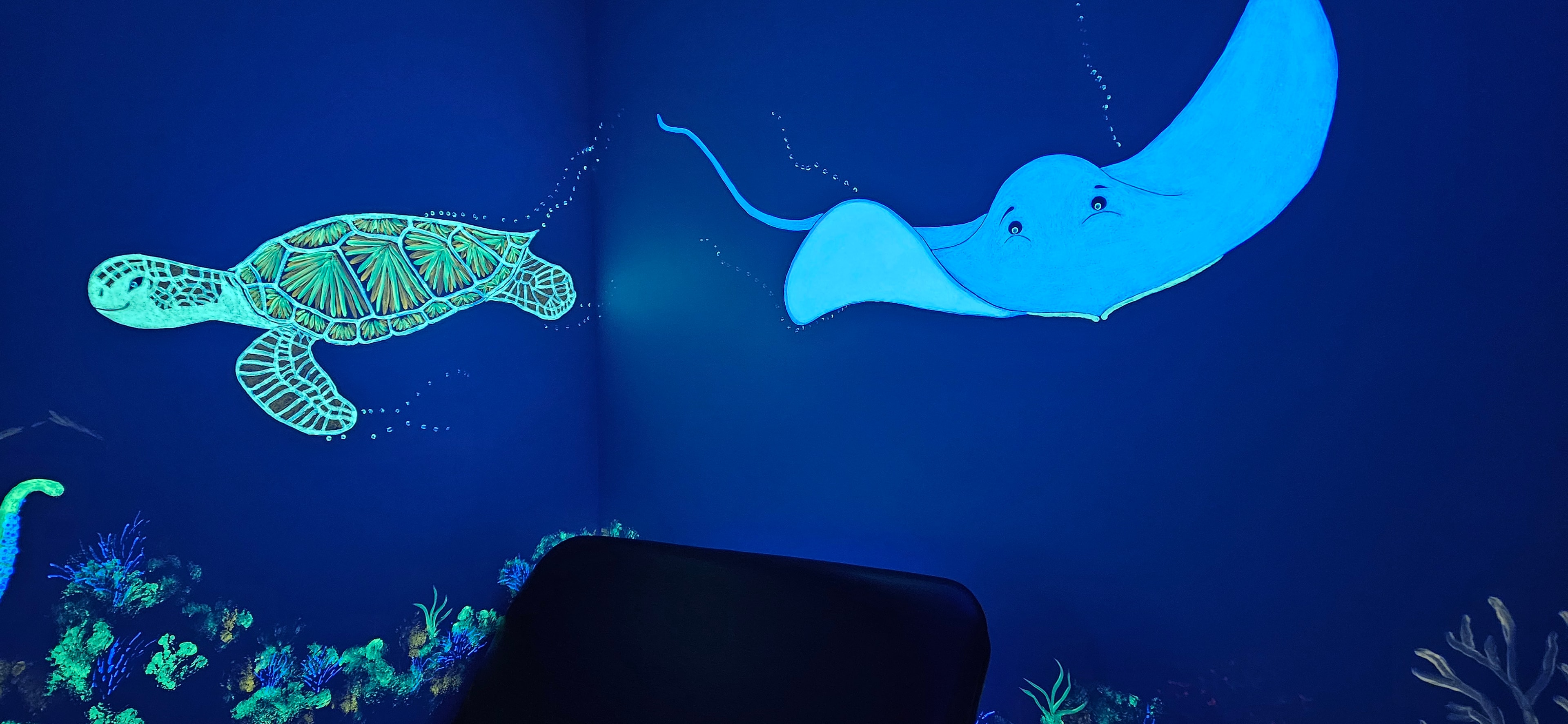 Ocean room glowing with sea creatures under black light