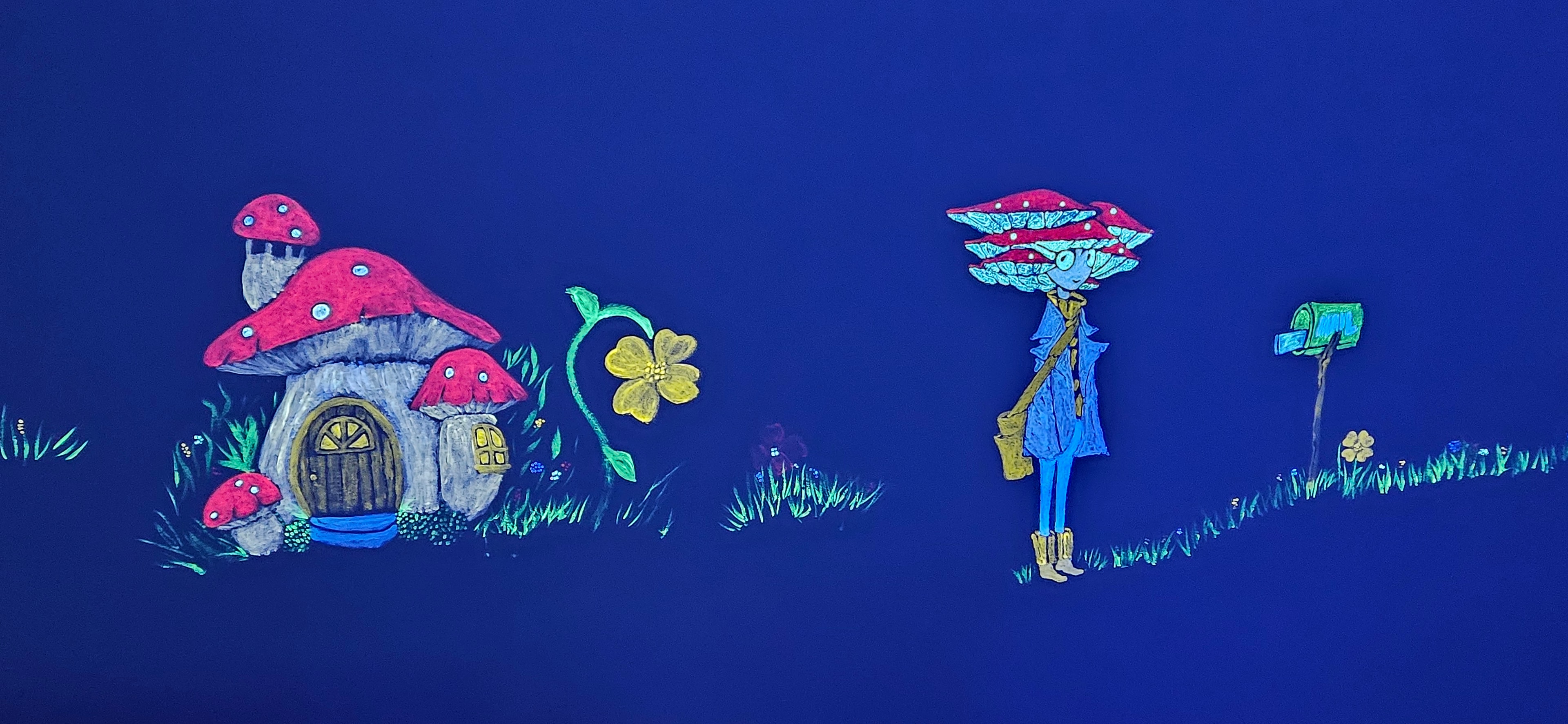 Glowing mushroom house village with fairy character under black light in the Fantasy Room