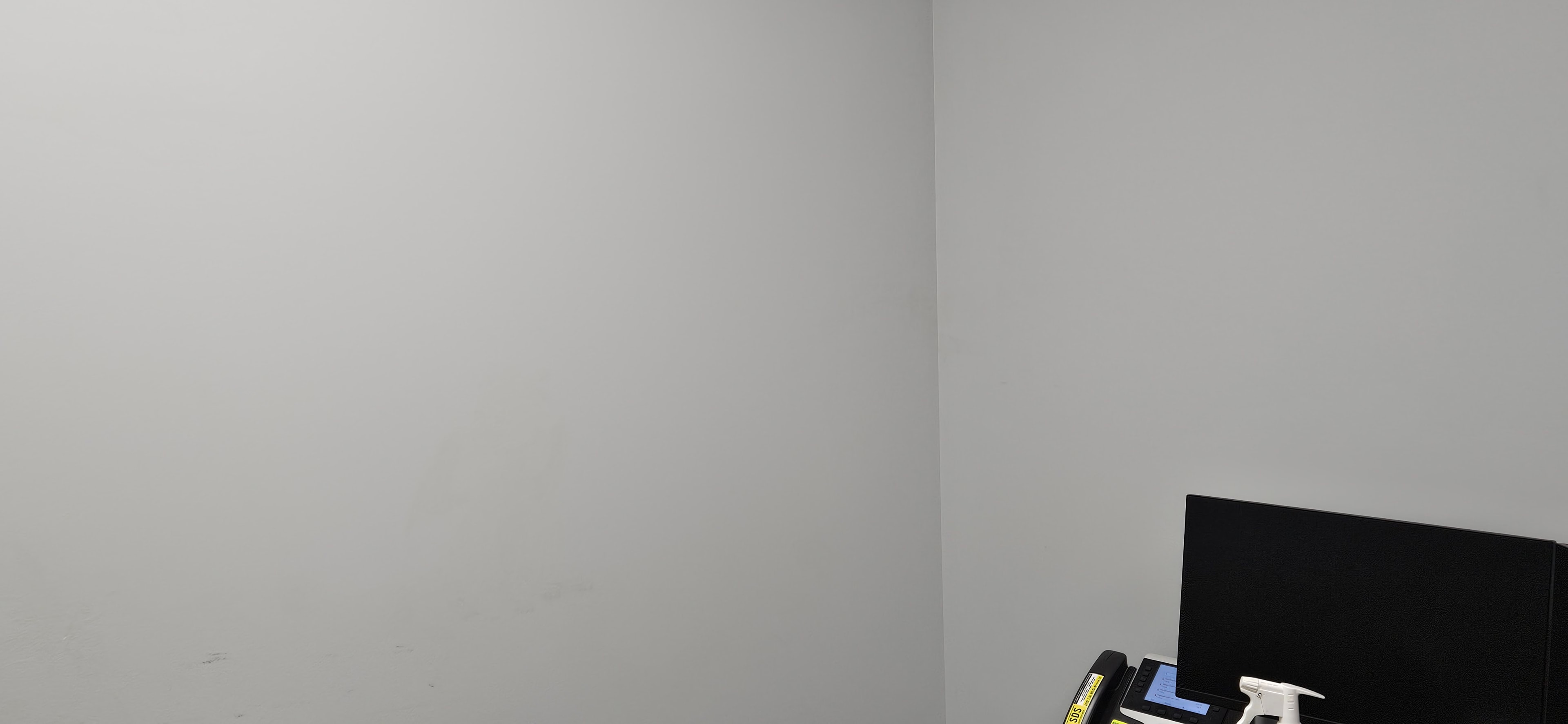 Plain grey corner with medical equipment before the Fantasy Room mural was painted