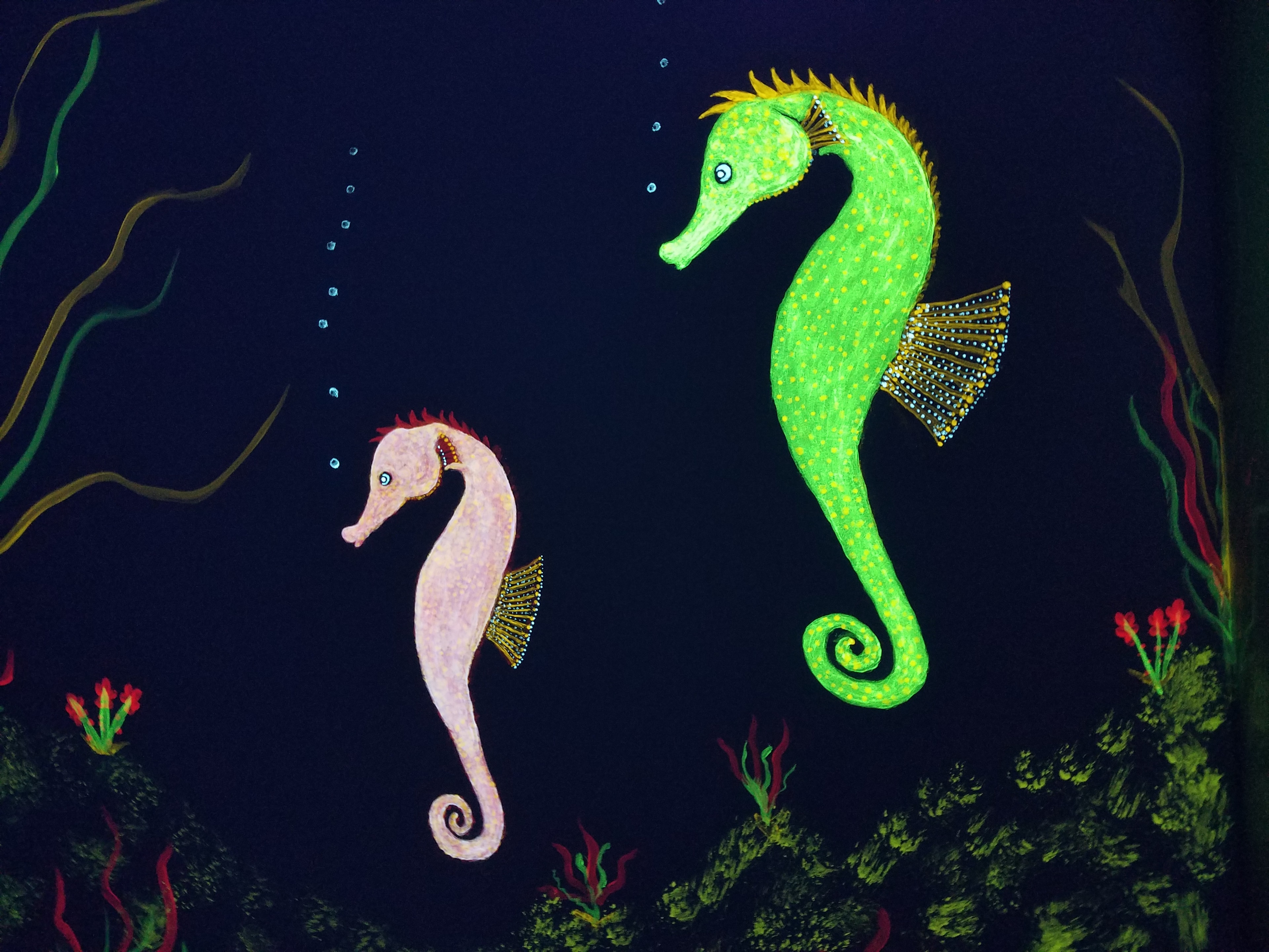 Glowing seahorses painted on the Ocean Room wall under black light